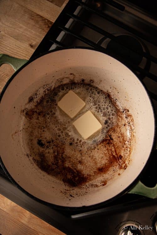 cubes of butter melting in a large pan on the stovetop