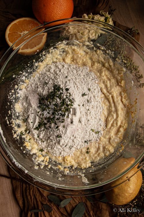 lemon bread mix with flour and thyme in a glass mixing bowl