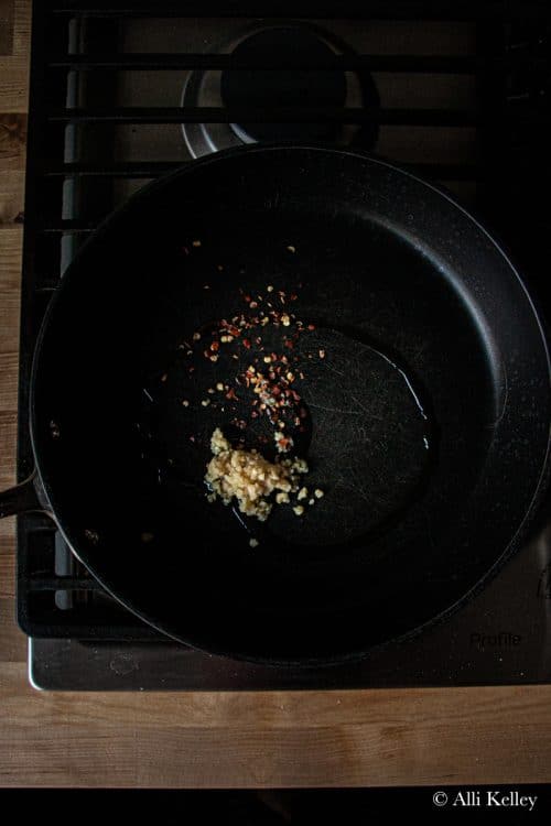 minced garlic and red pepper flakes in a skillet on the stovetop