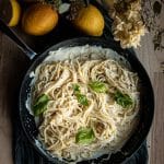 lemon ricotta pasta in a skillet garnished with fresh herbs