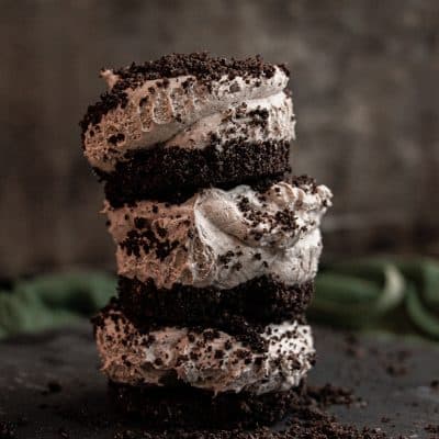 stacked oreo cheesecake bites topped with crushed oreos