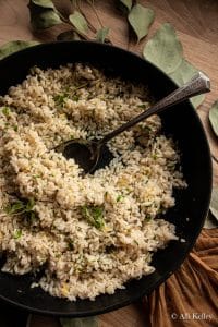 garlic and herb rice in a bowl with a spoon