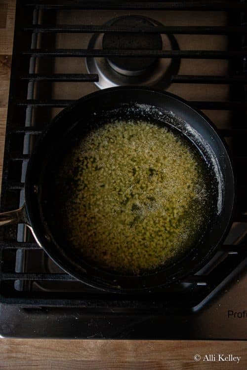 melted butter and minced garlic in a pan on the stove