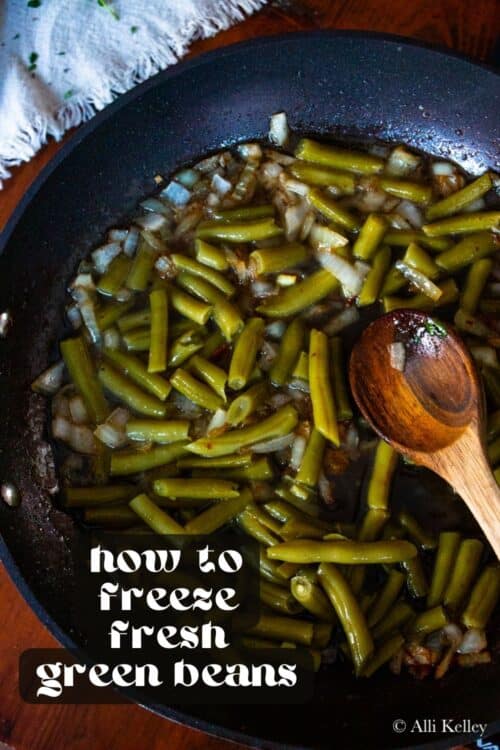 A skillet filled with cooked green beans and chopped onions in liquid, with a wooden spoon to the side. Text on the image reads: how do you freeze green beans.